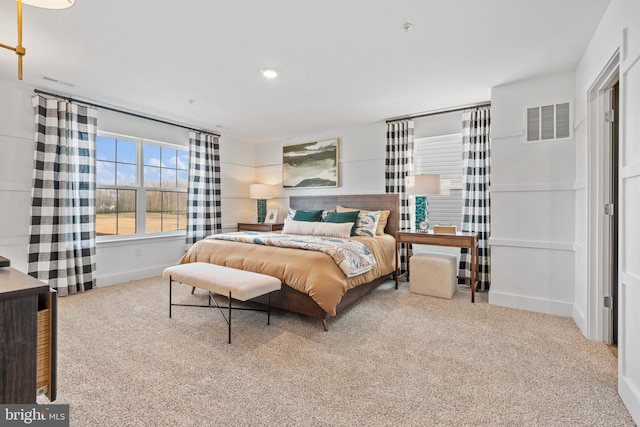 carpeted bedroom featuring baseboards and visible vents