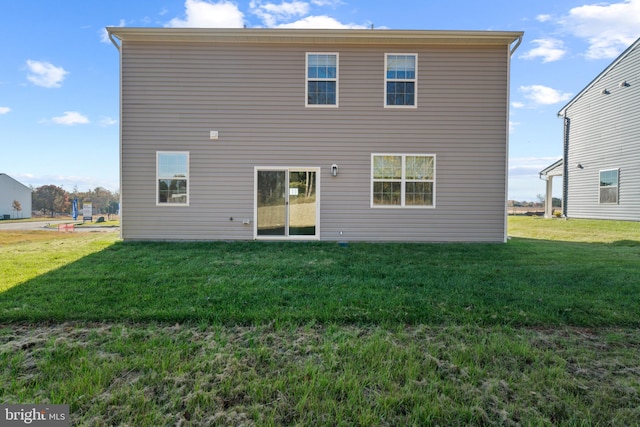 rear view of property with a yard