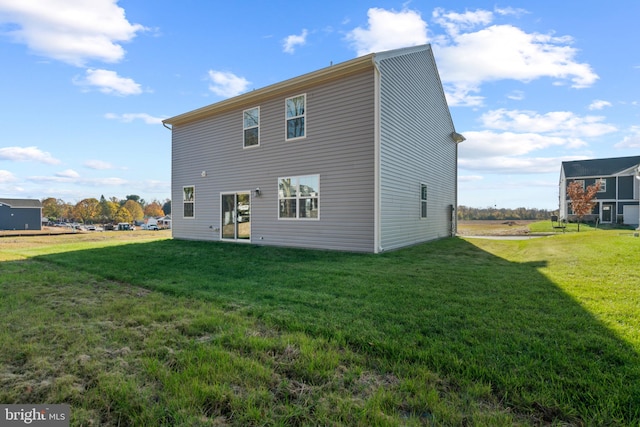 back of property featuring a lawn