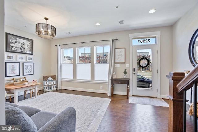 entryway with dark wood finished floors, recessed lighting, baseboards, and visible vents