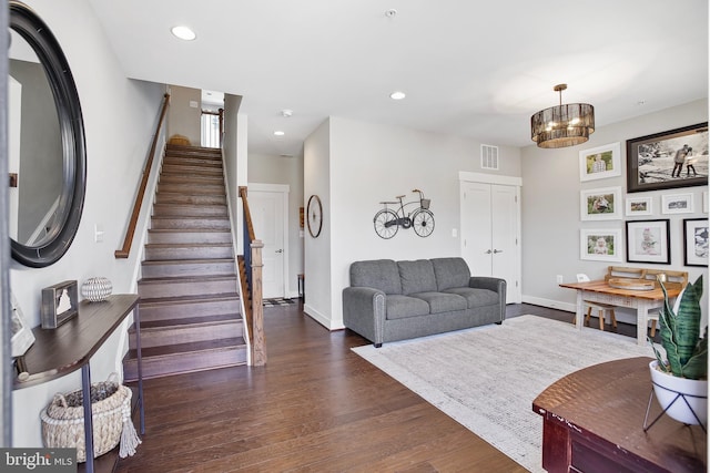 living room with stairs, recessed lighting, visible vents, and dark wood-style flooring