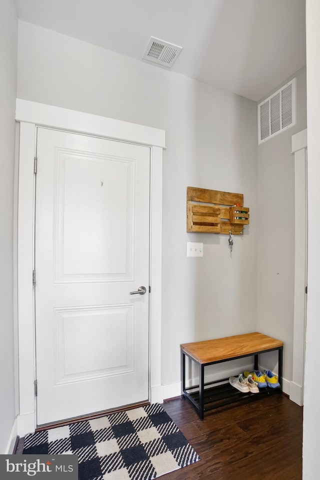 mudroom featuring visible vents, baseboards, and wood finished floors