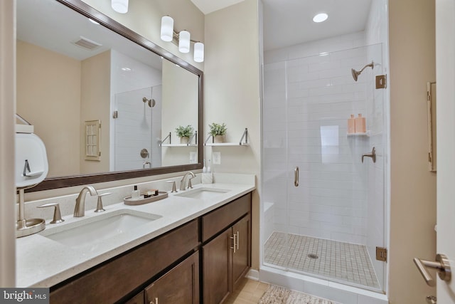 bathroom featuring a sink, visible vents, double vanity, and a shower stall