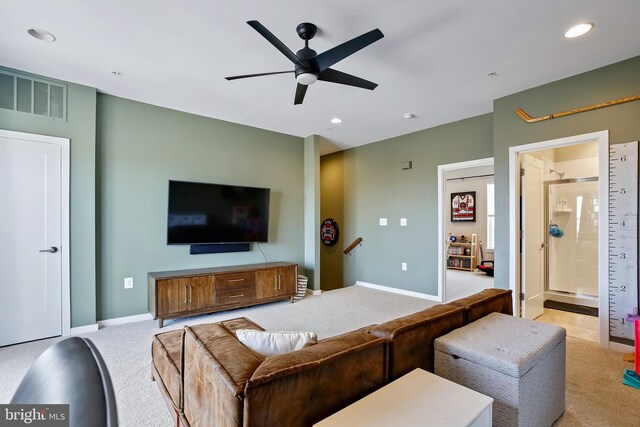 living room with recessed lighting, visible vents, and light colored carpet