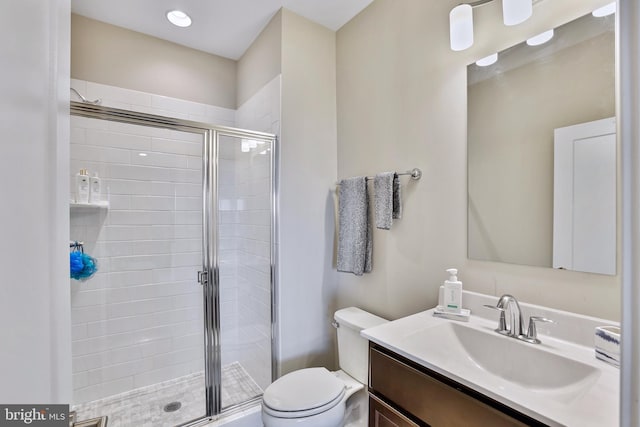 full bathroom featuring vanity, toilet, and a stall shower