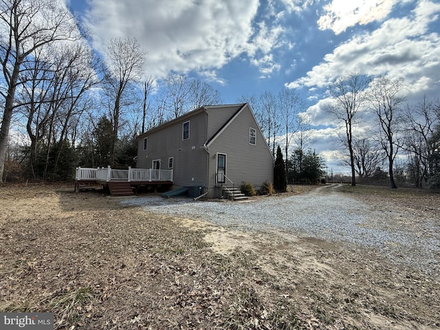 view of home's exterior featuring a wooden deck