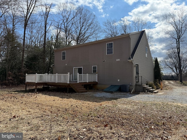 back of property featuring a deck and cooling unit