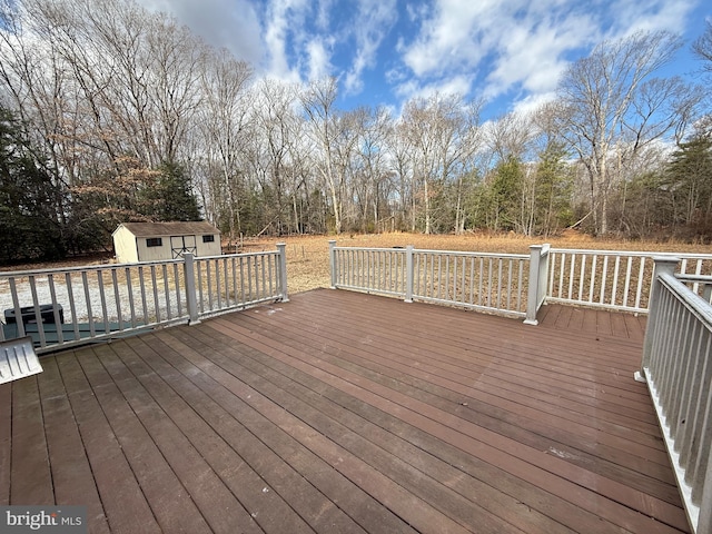 deck with an outbuilding and a shed