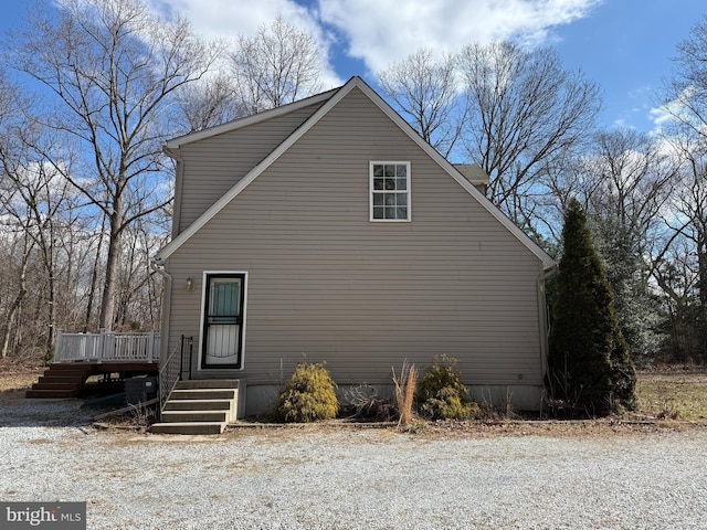 view of side of home featuring a wooden deck