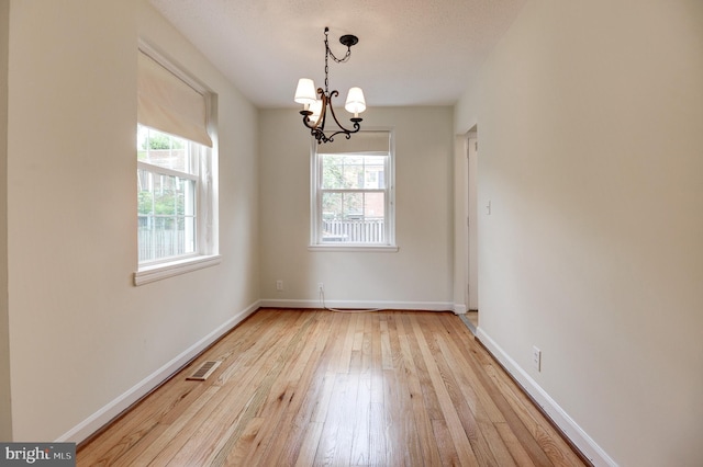 4911 29th Rd S, Arlington, VA 22206 - empty room featuring healthy amount of natural light, hardwood / wood-style floors, a chandelier, and baseboards