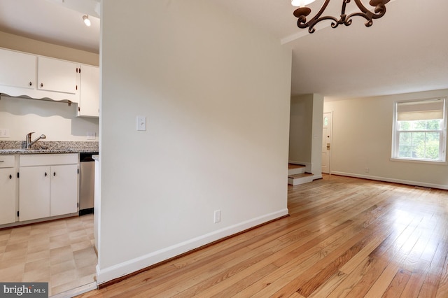 4911 29th Rd S, Arlington, VA 22206 - kitchen with a chandelier, white cabinets, stainless steel dishwasher, and baseboards