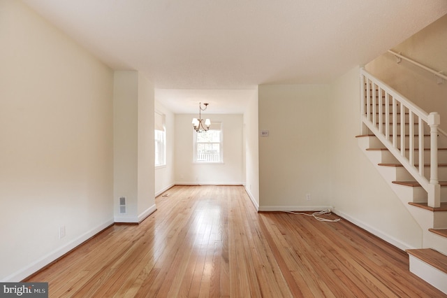 4911 29th Rd S, Arlington, VA 22206 - unfurnished living room featuring a chandelier, hardwood / wood-style flooring, stairs, and baseboards