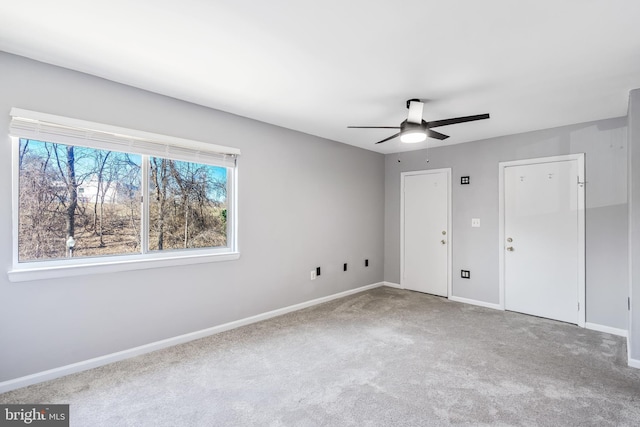 interior space featuring a ceiling fan, baseboards, and carpet floors