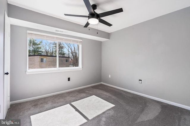 carpeted empty room with visible vents, ceiling fan, and baseboards