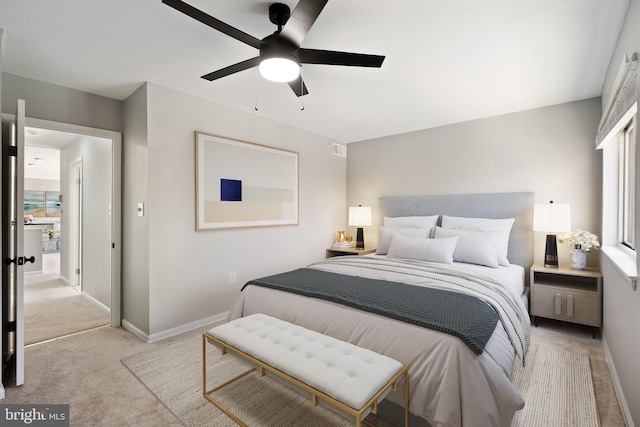 bedroom featuring visible vents, baseboards, light colored carpet, and a ceiling fan