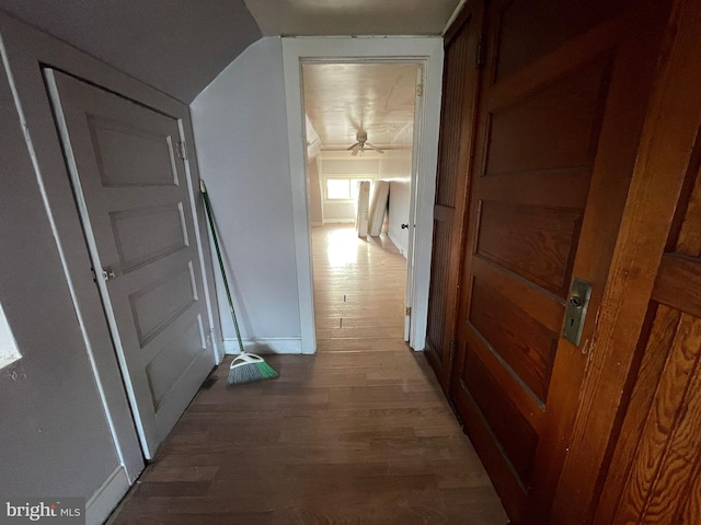 hallway featuring baseboards and wood finished floors