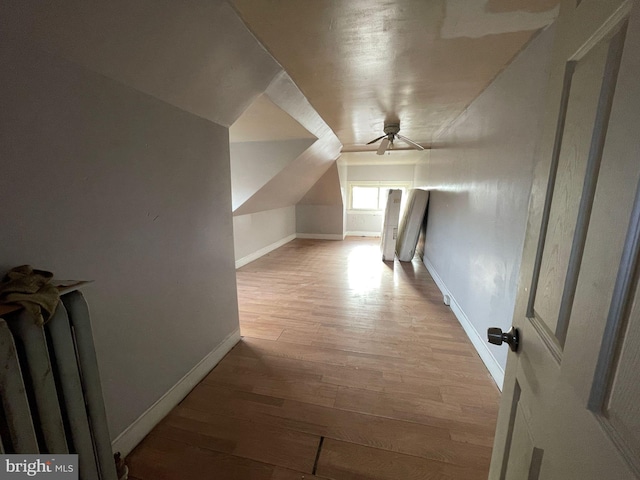 bonus room with lofted ceiling, wood finished floors, and baseboards