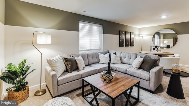 living room with baseboards and light colored carpet