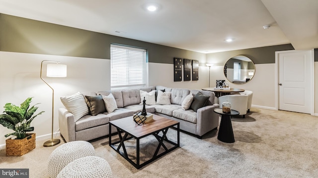 living area featuring recessed lighting, light carpet, and baseboards