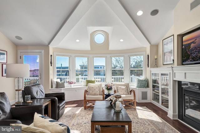 living room featuring visible vents, dark wood finished floors, recessed lighting, vaulted ceiling, and a glass covered fireplace