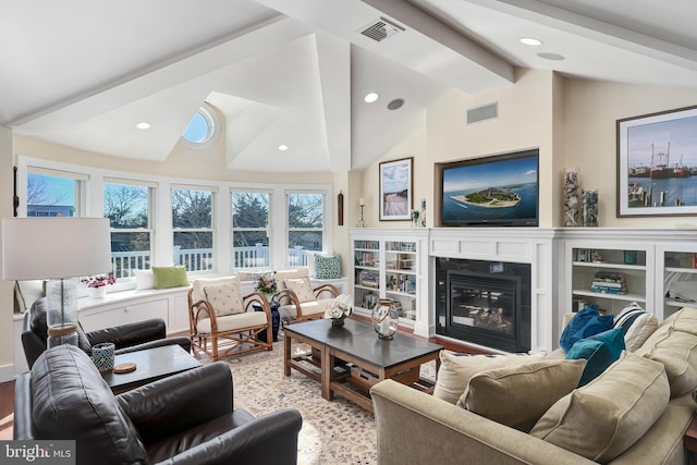 living room featuring visible vents, recessed lighting, vaulted ceiling with beams, and a glass covered fireplace