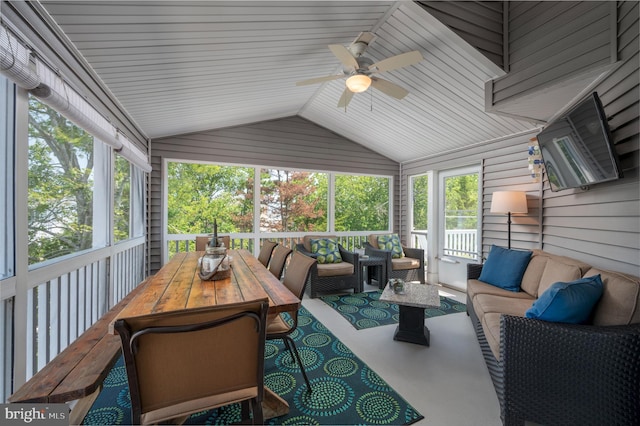 sunroom with a ceiling fan and vaulted ceiling