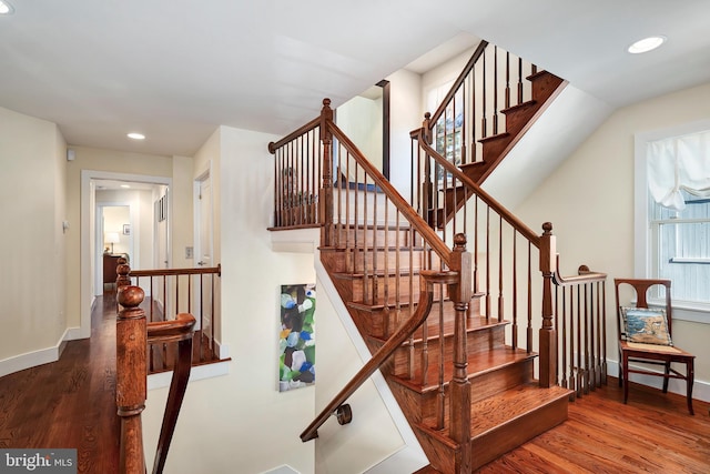 stairway with recessed lighting, baseboards, and wood finished floors