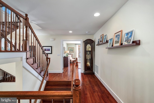 stairs with visible vents, recessed lighting, baseboards, and wood finished floors