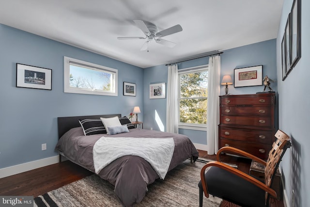 bedroom with ceiling fan, baseboards, and wood finished floors