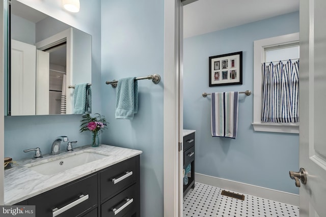 bathroom with vanity and baseboards