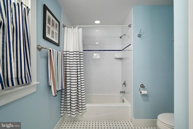 bathroom featuring tile patterned flooring, baseboards, toilet, recessed lighting, and shower / tub combo