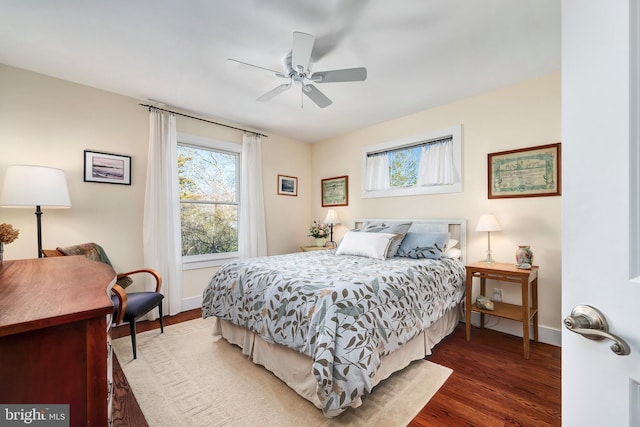 bedroom with baseboards, wood finished floors, and a ceiling fan