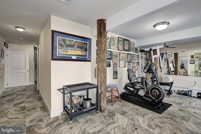 workout area with baseboards and marble finish floor