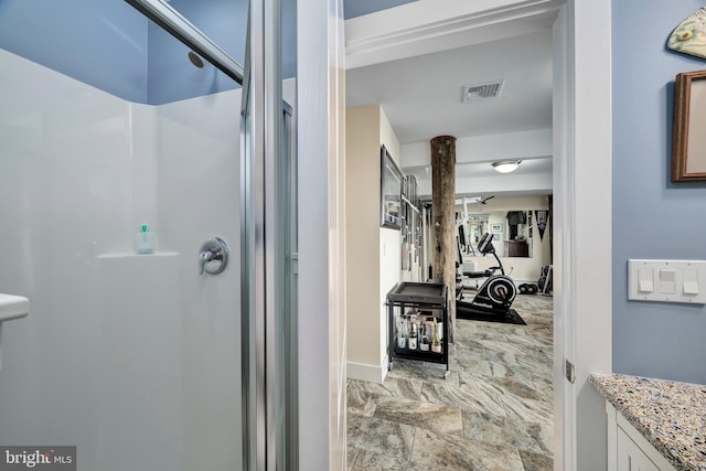 bathroom with visible vents and a shower stall