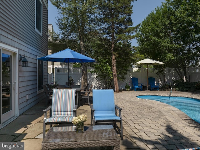 view of swimming pool featuring a fenced in pool, a patio, outdoor dining area, and a fenced backyard