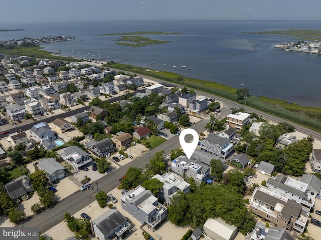 drone / aerial view featuring a water view and a residential view