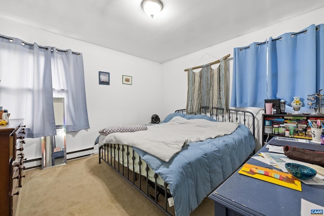 bedroom featuring a baseboard heating unit and carpet floors