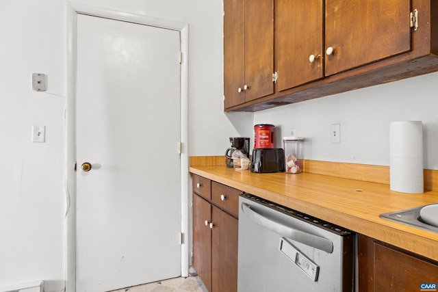 kitchen featuring brown cabinets, light countertops, and dishwasher