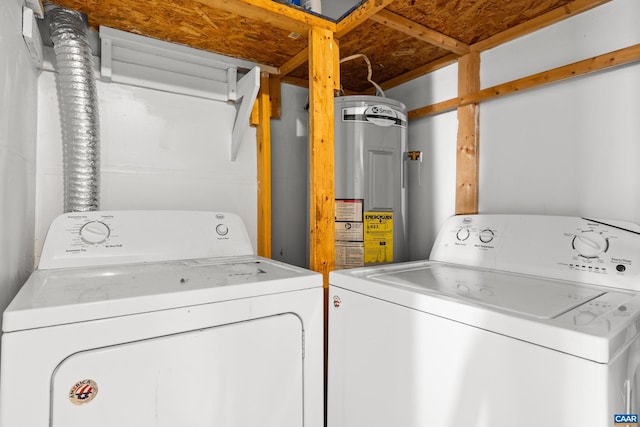 clothes washing area with laundry area, electric water heater, and independent washer and dryer