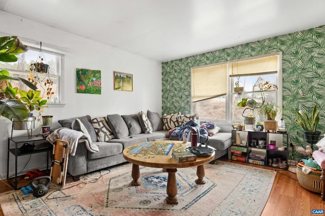 living room with wallpapered walls and wood finished floors