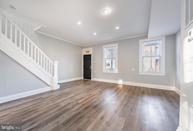 foyer entrance with wood finished floors, recessed lighting, crown molding, baseboards, and stairs