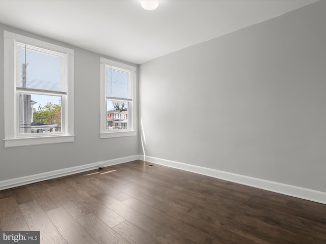 607 N Longwood St, Baltimore, MD 21216 - spare room featuring baseboards and dark wood-style floors