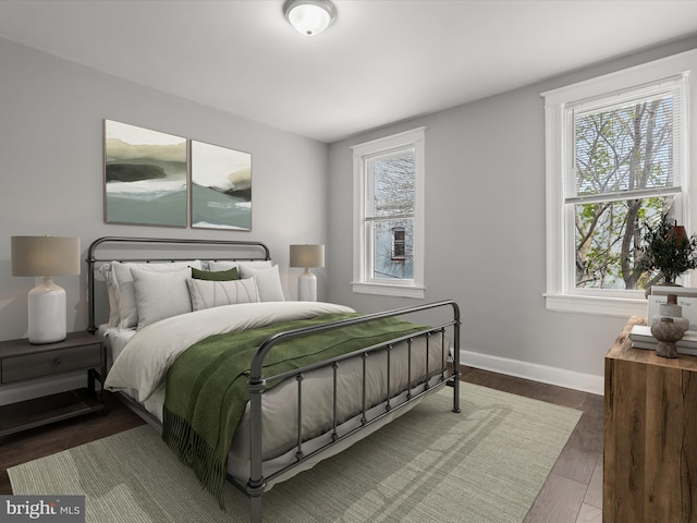 607 N Longwood St, Baltimore, MD 21216 - bedroom featuring wood finished floors, baseboards, and multiple windows