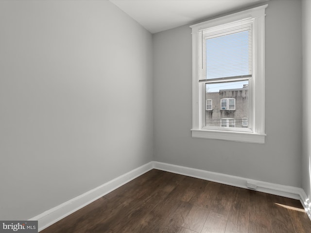 607 N Longwood St, Baltimore, MD 21216 - unfurnished room featuring baseboards and dark wood-style floors