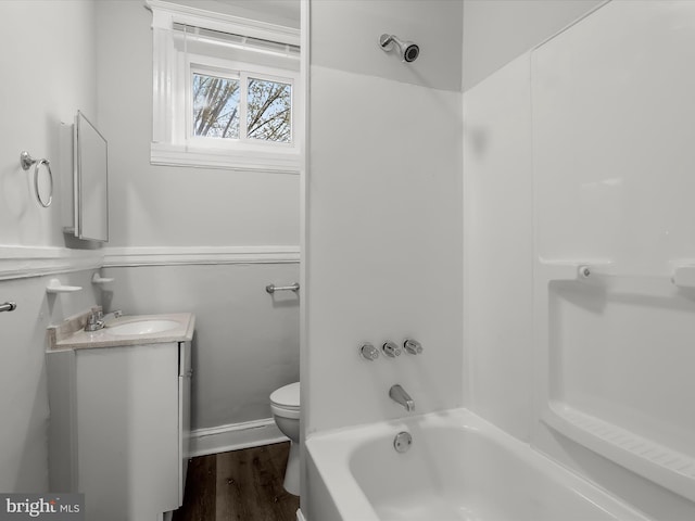 607 N Longwood St, Baltimore, MD 21216 - full bath with toilet, washtub / shower combination, vanity, and wood finished floors