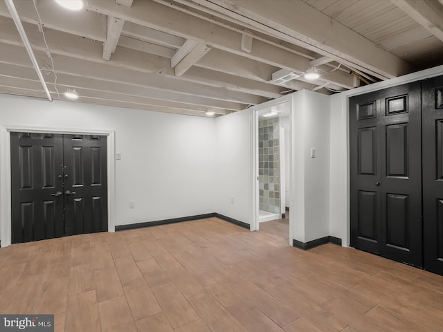 607 N Longwood St, Baltimore, MD 21216 - finished basement with light wood-style flooring and baseboards