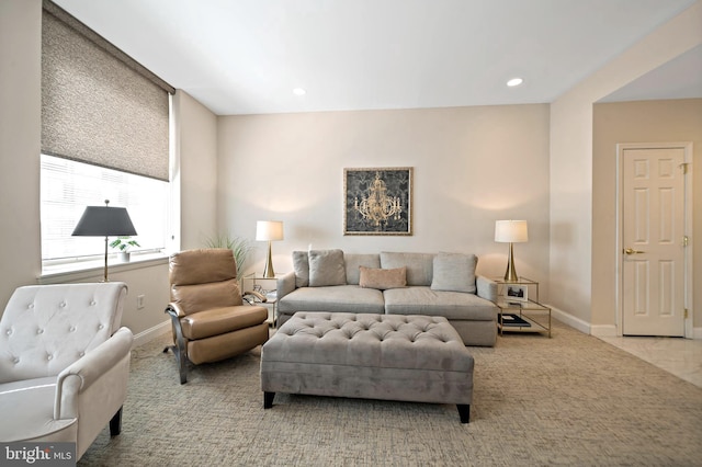 carpeted living area featuring recessed lighting and baseboards