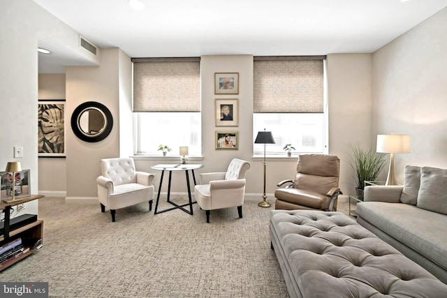 living room featuring baseboards, visible vents, and carpet floors