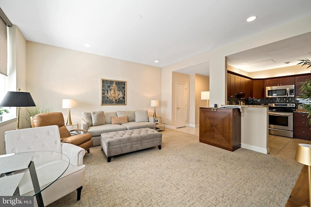 living area with light tile patterned floors, baseboards, and recessed lighting