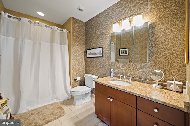 bathroom with visible vents, a shower with curtain, toilet, tile patterned flooring, and vanity